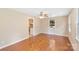 Bright living room featuring gleaming hardwood floors, large windows, and neutral wall colors at 2701 Ravencroft Dr, Charlotte, NC 28208
