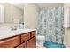 Bathroom featuring vanity with cherry cabinets and shower-tub combo at 2840 Hopeton Ct, Monroe, NC 28110