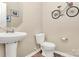 Bright half bath featuring a pedestal sink and bike decor at 2840 Hopeton Ct, Monroe, NC 28110