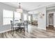 Bright dining area with natural light, wood floors, and a modern chandelier, leading to living areas at 2840 Hopeton Ct, Monroe, NC 28110