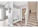 Inviting entryway with coat hooks, bench, cubbies, and staircase at 2840 Hopeton Ct, Monroe, NC 28110