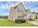Attractive tan siding townhouse with teal door, blue shutters and manicured landscaping at 2840 Hopeton Ct, Monroe, NC 28110