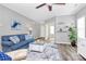 Comfortable living room with gray walls, wood floors, blue sofa, and neutral decor at 2840 Hopeton Ct, Monroe, NC 28110