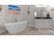 Bright bathroom featuring a standalone tub with modern faucet and a vanity with black marble countertop at 3011 Waxhaw Crossing Dr, Waxhaw, NC 28173