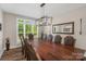 Formal dining room featuring a large window, modern chandelier, and seating for eight or more at 3011 Waxhaw Crossing Dr, Waxhaw, NC 28173