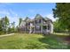 Landscaped front yard of a two-story home featuring a blend of brick and gray siding at 3011 Waxhaw Crossing Dr, Waxhaw, NC 28173