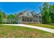 Two-story home featuring an attached garage, complemented by lush landscaping and mature trees at 3011 Waxhaw Crossing Dr, Waxhaw, NC 28173