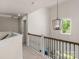 Second story hallway with modern railing, an attractive chandelier, and a window with a green view at 3011 Waxhaw Crossing Dr, Waxhaw, NC 28173