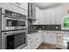 Gourmet kitchen featuring modern appliances, mosaic backsplash, and sleek cabinetry at 3011 Waxhaw Crossing Dr, Waxhaw, NC 28173