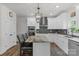 Bright kitchen features white cabinets, stainless steel appliances, granite countertops, and center island with seating at 3011 Waxhaw Crossing Dr, Waxhaw, NC 28173