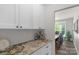 Convenient walk-in pantry with granite countertops and additional cabinetry located just off of the dining area at 3011 Waxhaw Crossing Dr, Waxhaw, NC 28173