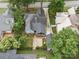 Aerial view of the home's backyard featuring a screened-in porch, detached garage, and landscaped backyard at 308 W Monroe St, Salisbury, NC 28144