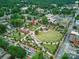 Aerial view of a town square with green space, walkways, and historical buildings surrounded by lush trees at 308 W Monroe St, Salisbury, NC 28144