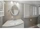 Well-lit bathroom with a corner sink and mirror at 308 W Monroe St, Salisbury, NC 28144