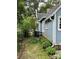 A charming blue house with manicured garden beds and healthy green landscaping surrounding the home at 308 W Monroe St, Salisbury, NC 28144