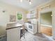 Efficient kitchen includes a movable island, white appliances, natural light, and a view into the next room at 308 W Monroe St, Salisbury, NC 28144