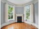 Cozy room with fireplace, hardwood floors and natural light from large windows at 308 W Monroe St, Salisbury, NC 28144