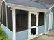 Exterior view of the screened-in porch featuring the door, screens, and painted blue bead board at 308 W Monroe St, Salisbury, NC 28144