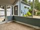 View of the outdoor shed from the screened porch with wooden flooring and painted bead board on the lower walls at 308 W Monroe St, Salisbury, NC 28144