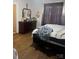 Comfortable bedroom with hardwood floors, a dresser, and neutral colored walls at 325 N Caldwell Ave, Newton, NC 28658