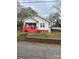 Charming home featuring a covered front porch, vibrant red foundation, and a detached carport at 325 N Caldwell Ave, Newton, NC 28658