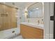 Modern bathroom featuring double vanity, wood-look accent wall, and glass shower at 3326 Winterfield Pl, Charlotte, NC 28205