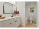 Bright bathroom features white cabinetry, a modern mirror, and tub/shower combination at 3326 Winterfield Pl, Charlotte, NC 28205