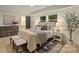 Inviting bedroom boasts warm decor, furniture, and ample sunlight at 3326 Winterfield Pl, Charlotte, NC 28205