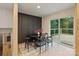 Cozy dining area with black accent wall, modern table set, and access to a charming outdoor deck at 3326 Winterfield Pl, Charlotte, NC 28205