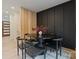 Stylish dining area with a round table, black chairs, and a unique wood slat partition at 3326 Winterfield Pl, Charlotte, NC 28205