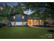 Charming two-story home features a striking dark and white exterior, complemented by a well-manicured front yard at 3326 Winterfield Pl, Charlotte, NC 28205