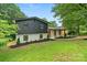 The home features a striking dark and white exterior, complemented by a well-manicured front yard and professional landscaping at 3326 Winterfield Pl, Charlotte, NC 28205