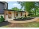 Inviting front porch featuring natural wood columns, tasteful landscaping, and a stylish front door with a wreath at 3326 Winterfield Pl, Charlotte, NC 28205