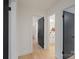 Open hallway showcasing modern doors, light hardwood floors, and access to various rooms at 3326 Winterfield Pl, Charlotte, NC 28205
