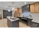 Modern kitchen with stainless steel appliances, island sink, and stylish pendant lighting at 3326 Winterfield Pl, Charlotte, NC 28205