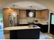 An open kitchen with modern appliances, a large island, and stylish pendant lighting is seen at 3326 Winterfield Pl, Charlotte, NC 28205