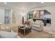 Bright living room with an archway leading to a modern kitchen and stairs at 3326 Winterfield Pl, Charlotte, NC 28205