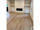 A bright living room with modern fireplace, built-in shelves, and light wood flooring at 3326 Winterfield Pl, Charlotte, NC 28205