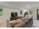 Relaxing living room with a gray couch, neutral chairs, and abundant natural light at 3326 Winterfield Pl, Charlotte, NC 28205