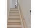 Staircase with light wood treads and white risers, complemented by a natural wood handrail at 3326 Winterfield Pl, Charlotte, NC 28205