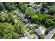 Aerial shot showcasing a property in a lush, green neighborhood with mature trees and nearby amenities at 361 5Th Nw St, Hickory, NC 28601
