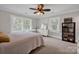 Cozy bedroom featuring a ceiling fan, large windows, and a comfortable bed at 361 5Th Nw St, Hickory, NC 28601