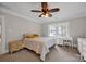Bright bedroom with neutral tones, featuring a ceiling fan, windows, and a comfortable bed at 361 5Th Nw St, Hickory, NC 28601