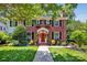 Charming two-story brick home with a red door and meticulously landscaped front yard at 361 5Th Nw St, Hickory, NC 28601