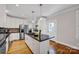 Modern kitchen with a central island, stainless steel appliances, and white cabinets at 361 5Th Nw St, Hickory, NC 28601
