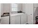 Practical laundry room with a sink, washer, dryer, and storage for convenience at 361 5Th Nw St, Hickory, NC 28601