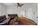 Inviting living room with a leather couch, decorative rug, and ceiling fan for added comfort at 361 5Th Nw St, Hickory, NC 28601
