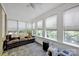 Bright sunroom featuring tile floors, ample windows, and a comfortable seating area at 361 5Th Nw St, Hickory, NC 28601