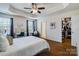 Spacious bedroom with hardwood floors, a tray ceiling, a closet, and a desk area at 4060 Zilker Park Dr, Charlotte, NC 28217
