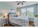 Cozy bedroom with a large window, wood floors, and blue patterned bedding at 4060 Zilker Park Dr, Charlotte, NC 28217
